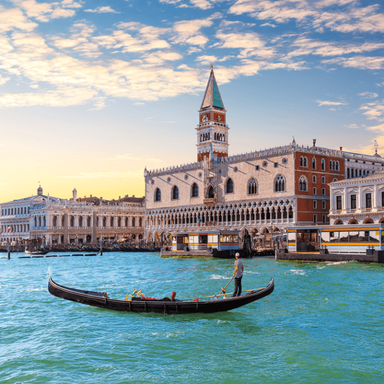 A gondola floating in the pristine turquoise canal waters of Venice, Italy
